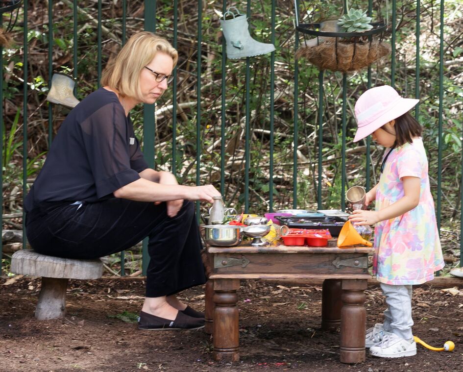 Katie and one child mud kitchen