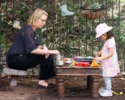 Katie and one child mud kitchen